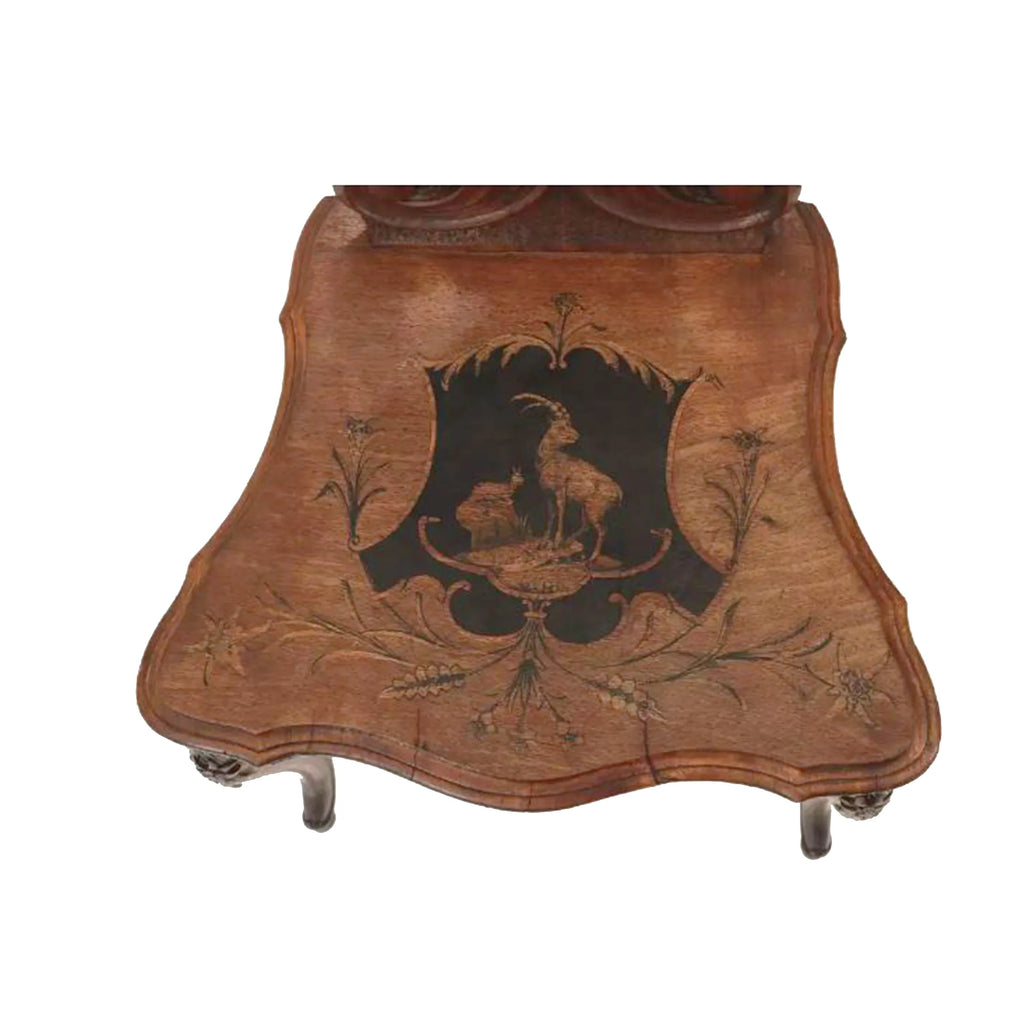 A 19TH C HAND CARVED AND INLAID BLACK FOREST CHAIR